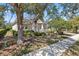Well-maintained home exterior with a paved driveway, charming front porch, and verdant landscaping, offering a welcoming appeal at 1205 Draycott St, Ormond Beach, FL 32174