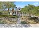 Charming home with a well-manicured front yard, featuring mature trees and manicured hedges, enhancing curb appeal at 1205 Draycott St, Ormond Beach, FL 32174