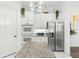 Bright kitchen with stainless steel appliances, granite countertops, white cabinetry, and a pantry at 1205 Draycott St, Ormond Beach, FL 32174