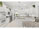 Open kitchen featuring granite countertops, white cabinetry, stainless steel appliances, and a center island at 1205 Draycott St, Ormond Beach, FL 32174