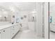 Bright main bathroom featuring dual sinks, vanity, bathtub and glass enclosed shower at 1205 Draycott St, Ormond Beach, FL 32174
