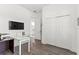 Office area with white walls, laminate flooring, desk, and storage at 1205 Draycott St, Ormond Beach, FL 32174
