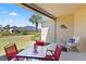 Outdoor patio with comfortable seating, offering a peaceful view of the green backyard and blue skies at 1205 Draycott St, Ormond Beach, FL 32174