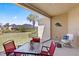 Covered patio with comfortable seating, overlooking a well-manicured lawn and lush landscaping at 1205 Draycott St, Ormond Beach, FL 32174
