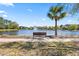 Scenic pond view with a tranquil fountain and bench, inviting residents to unwind and enjoy the peaceful surroundings at 1205 Draycott St, Ormond Beach, FL 32174