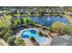 Community pool and splashpad with lake views surrounded by mature trees at 1205 Draycott St, Ormond Beach, FL 32174