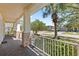 Inviting front porch showcasing stone accents on the support beams, with a view of the tranquil street and neighborhood at 1205 Draycott St, Ormond Beach, FL 32174