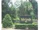 Community entrance sign surrounded by lush greenery and manicured bushes at 123 Tomoka Trl # 123, Longwood, FL 32779