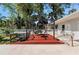 Backyard patio area with gazebo and seating with lush tropical plants at 1254 Mardrake Rd, Daytona Beach, FL 32114