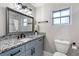 Updated bathroom with granite countertops, a decorative mirror, and modern fixtures at 1254 Mardrake Rd, Daytona Beach, FL 32114