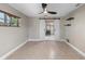 Bedroom with tile floors, barn door leading to closet, and floating shelves at 1254 Mardrake Rd, Daytona Beach, FL 32114