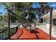 Outdoor deck featuring a pergola, hanging chairs, and table, perfect for relaxation at 1254 Mardrake Rd, Daytona Beach, FL 32114