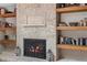 Elegant stone fireplace with decorative iron screen and adjacent shelving at 1254 Mardrake Rd, Daytona Beach, FL 32114