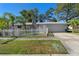 Ranch home featuring an attached garage and manicured front lawn with a white picket fence at 1254 Mardrake Rd, Daytona Beach, FL 32114