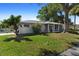 Charming single-story home with a cozy screened-in porch and lush green lawn at 1254 Mardrake Rd, Daytona Beach, FL 32114