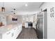 Bright, open kitchen featuring white cabinetry, stainless steel appliances, and granite countertops at 1254 Mardrake Rd, Daytona Beach, FL 32114