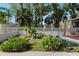 Scenic backyard showcasing a tranquil pond surrounded by lush greenery and a white fence at 1254 Mardrake Rd, Daytona Beach, FL 32114