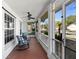 Cozy screened porch with rocking chairs, providing a relaxing outdoor living space at 1254 Mardrake Rd, Daytona Beach, FL 32114