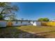 Large backyard featuring a wood fence, small storage shed, grass and the exterior of the home at 1304 Genmar St, Daytona Beach, FL 32117