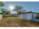 Spacious backyard featuring a wood fence, small storage shed, grass and the exterior of the home at 1304 Genmar St, Daytona Beach, FL 32117