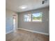 Well-lit bedroom with light wood flooring, neutral walls, and a window providing ample sunlight at 1304 Genmar St, Daytona Beach, FL 32117