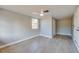 A light-filled bedroom with new flooring, neutral colors, a ceiling fan, and a window overlooking the yard at 1304 Genmar St, Daytona Beach, FL 32117