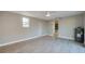 Spacious bedroom with a window, door, ceiling fan, and stylish wood-look flooring at 1304 Genmar St, Daytona Beach, FL 32117