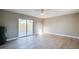 Bright bedroom featuring wood-look floors, neutral paint, ceiling fan, and sliding glass door to the patio at 1304 Genmar St, Daytona Beach, FL 32117