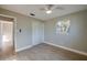 This bedroom features a ceiling fan, hardwood floors, a window and a closet with white paneled doors at 1304 Genmar St, Daytona Beach, FL 32117