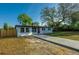 Charming single-story home with a well-manicured lawn, mature trees, and a paved driveway leading to the front entrance at 1304 Genmar St, Daytona Beach, FL 32117