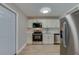 Functional kitchen with stainless steel appliances, white cabinetry, and easy access to adjacent rooms at 1304 Genmar St, Daytona Beach, FL 32117