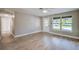 Bright living area featuring light wood floors, neutral walls, and a large window for lots of natural light at 1304 Genmar St, Daytona Beach, FL 32117