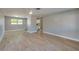 Inviting living room with light wood flooring, freshly painted walls, and an open layout to the kitchen at 1304 Genmar St, Daytona Beach, FL 32117