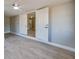 Open living area featuring gray walls, a ceiling fan, wood-look floors, and a partial view of the kitchen at 1304 Genmar St, Daytona Beach, FL 32117