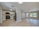 Open-concept living space with light wood flooring connecting the living room and the adjacent kitchen area at 1304 Genmar St, Daytona Beach, FL 32117