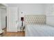 Bedroom features a tufted headboard, wood floors, and natural light at 1434 Deltona Blvd, Deltona, FL 32725