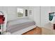 This bedroom features a white bed frame, wood flooring, and a double closet at 1434 Deltona Blvd, Deltona, FL 32725