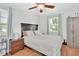 Cozy bedroom with a ceiling fan, wood floors, and ample natural light at 1434 Deltona Blvd, Deltona, FL 32725