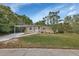 Charming single-story home featuring a cozy front porch and a convenient covered carport at 1434 Deltona Blvd, Deltona, FL 32725