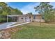 Charming single-story home featuring a cozy front porch and a convenient covered carport at 1434 Deltona Blvd, Deltona, FL 32725