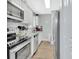 Modern kitchen with stainless steel appliances, white cabinets, and granite countertops at 1434 Deltona Blvd, Deltona, FL 32725