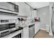 Bright kitchen with stainless steel appliances, granite countertops, and white cabinetry at 1434 Deltona Blvd, Deltona, FL 32725