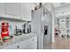 Bright kitchen with stainless steel refrigerator, granite countertops, and white cabinets at 1434 Deltona Blvd, Deltona, FL 32725