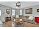 Comfortable living room featuring wood-look floors, a ceiling fan, and neutral decor at 1434 Deltona Blvd, Deltona, FL 32725