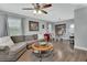 Comfortable living room with a ceiling fan, wood-look flooring, and a connecting dining area at 1434 Deltona Blvd, Deltona, FL 32725