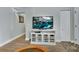 Living room features a television with a white cabinet and stylish wood-look flooring at 1434 Deltona Blvd, Deltona, FL 32725