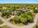 Aerial view of estate home with lush landscaping, circular driveway and surrounded by mature trees at 1450 Shady Meadow Ln, Deland, FL 32724