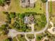 Overhead view shows the backyard of home with screened in pool and circular driveway at 1450 Shady Meadow Ln, Deland, FL 32724