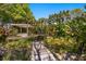 Picturesque backyard with a tranquil pond, lush greenery, and a charming bridge at 1450 Shady Meadow Ln, Deland, FL 32724