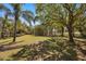 Large grassy backyard is surrounded by a wooden fence and shady trees at 1450 Shady Meadow Ln, Deland, FL 32724
